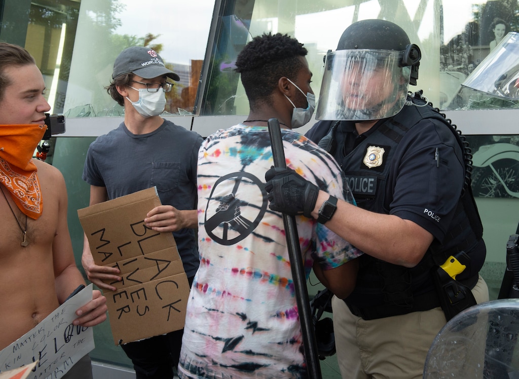 (Rick Egan  |  The Salt Lake Tribune)     Henry Kemp hugs a Salt Lake City Policeman at the Public Safety Building, during a demonstration,  He went down the line hugging every policeman in the line. Monday, June 1, 2020.