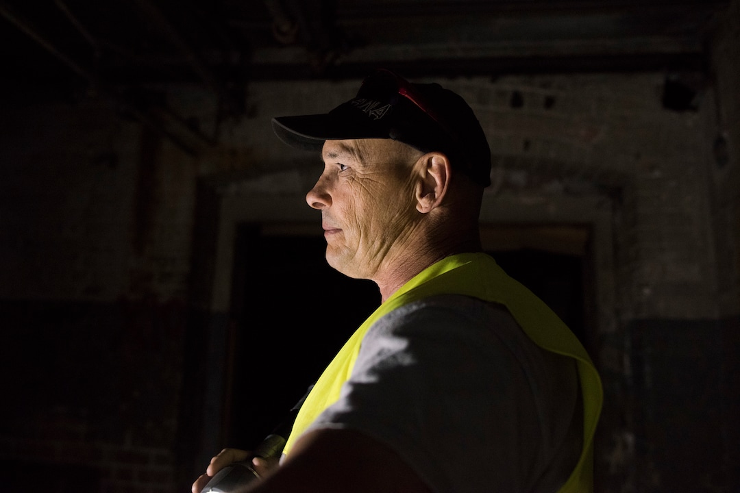 (Briana Scroggins  |  The Utah Investigative Journalism Project) EPA On-scene Coordinator Paul Peronard is lit by a flashlight while he wakes around the Swift building in Ogden on Thursday, May 16, 2019. The EPA started site clean up on April 1 and plan to finish by August 2019.