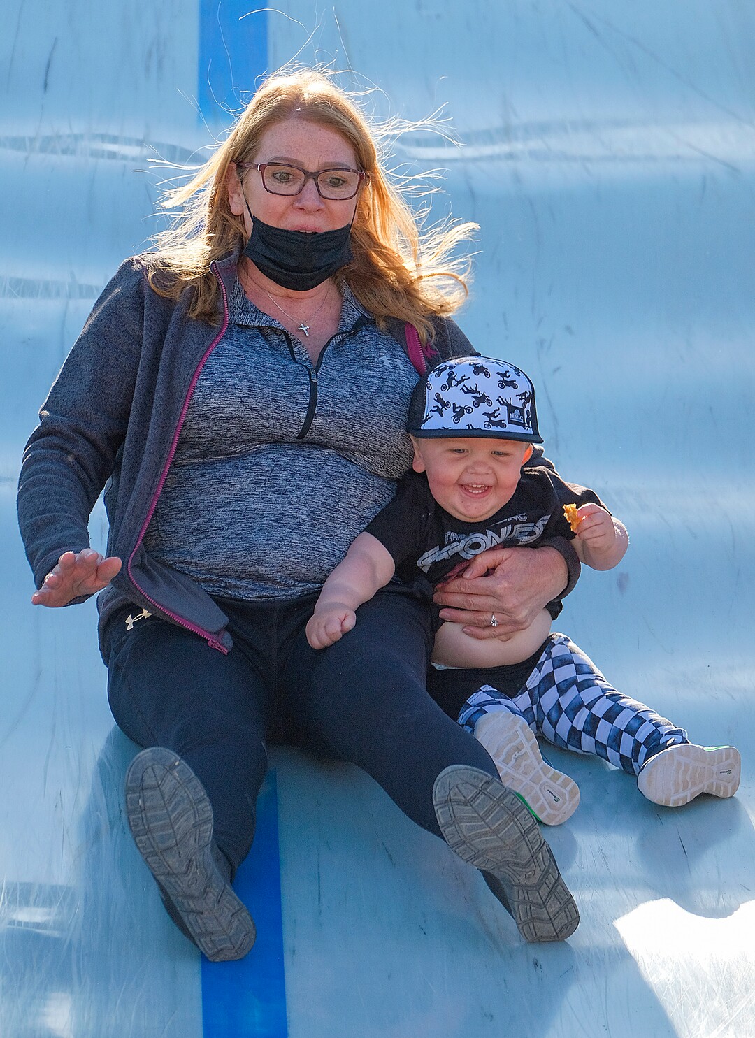 (Leah Hogsten | The Salt Lake Tribune) Tracy Lombardi and her grandson Daxton Glorioso, 20 months, react to the drops on the giant slide during the Baby Animal Festival  and Tulip Field Festival at Cross E Ranch April 23, 2021.The festival runs unlil May 8.