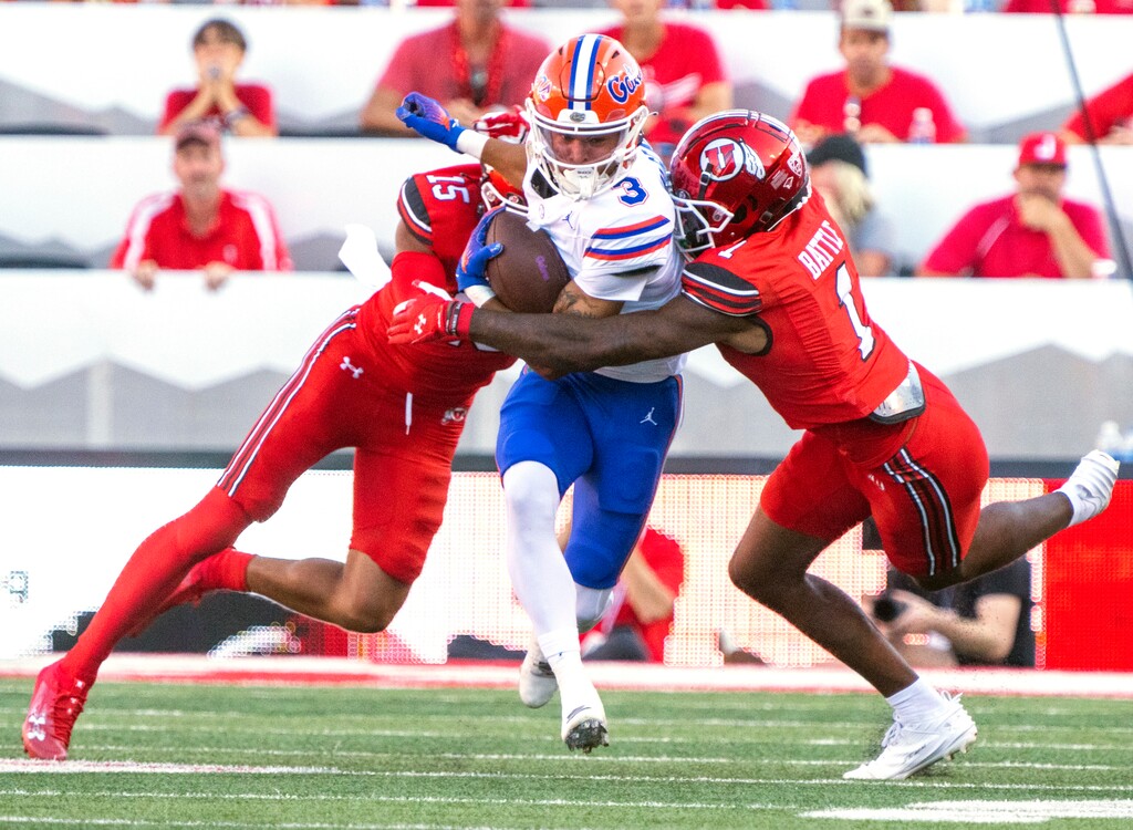 (Rick Egan | The Salt Lake Tribune) Utah Utes cornerback Tao Johnson (15) and Utah Utes cornerback Miles Battle (1) try to stop Florida Gators wide receiver Eugene Wilson (3), in football acton between the Utah Utes and the Florida Gators, at Rice-Eccles Stadium, on Thursday, Aug. 31, 2023.