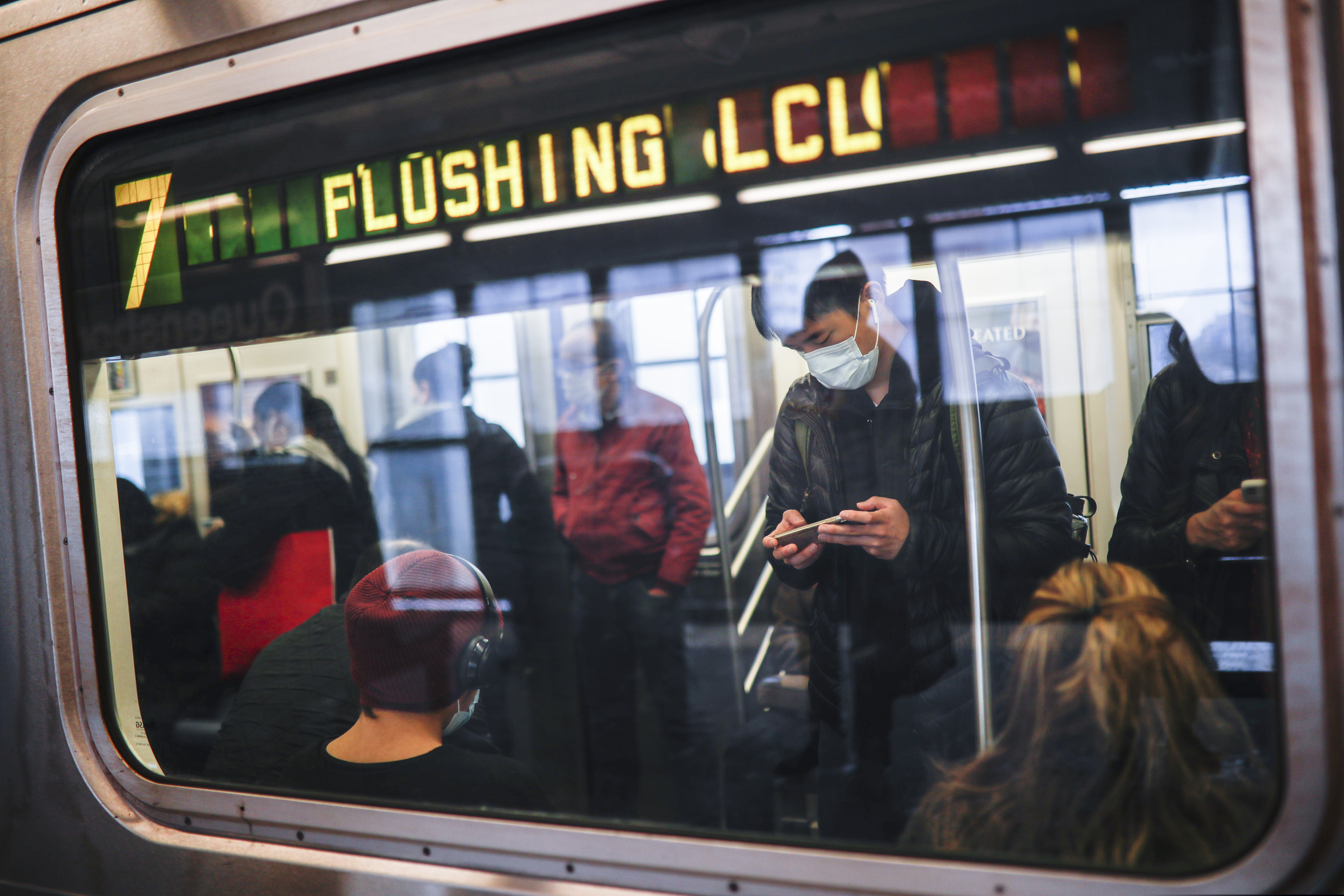In this April 7, 2020, photo, some people wear masks while using the New York City subway system during the coronavirus pandemic in New York. Last week, for the first time in New York's history, the trains stopped running in a planned shutdown. Between the hours of 1 a.m. and 5 a.m., the subways and New York's 472 stations began closing for a nightly cleaning to disinfect trains. It's a humbling concession for a swaggering, all-night town that, as much as anything, shows how the coronavirus pandemic has seized the gears of New York, one of the world's hardest hit cities. (AP Photo/John Minchillo)