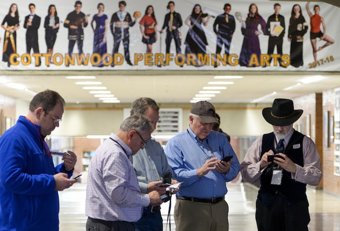 (Leah Hogsten  |  The Salt Lake Tribune) Delegates are glued to their phones in the commons area of Cottonwood High School at the Salt Lake County Republican Party Organizing Convention, Saturday, April 14, 2018.
