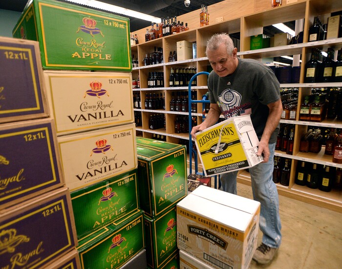 (Al Hartmann  |  The Salt Lake Tribune) 	Employee at the Cottonwood Heights state liquor store sorts through a big shipment of spirits Wednesday Nov. 22 to get it on the shelves.  The Wednesday before Thanksgiving is typically one of the busiest days for liquor sales in Utah. Customers typically line up outside before the 11 a.m. opening.   Extra employees work to handle the holiday rush. 