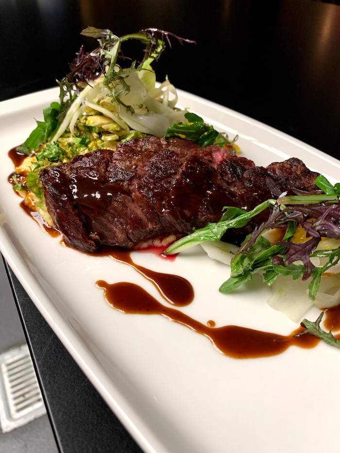 (Photo courtesy of SLC Eatery) Smoked bavette with creamy grits, brussel sprouts and a black garlic tamarind jus at SLC Eatery.