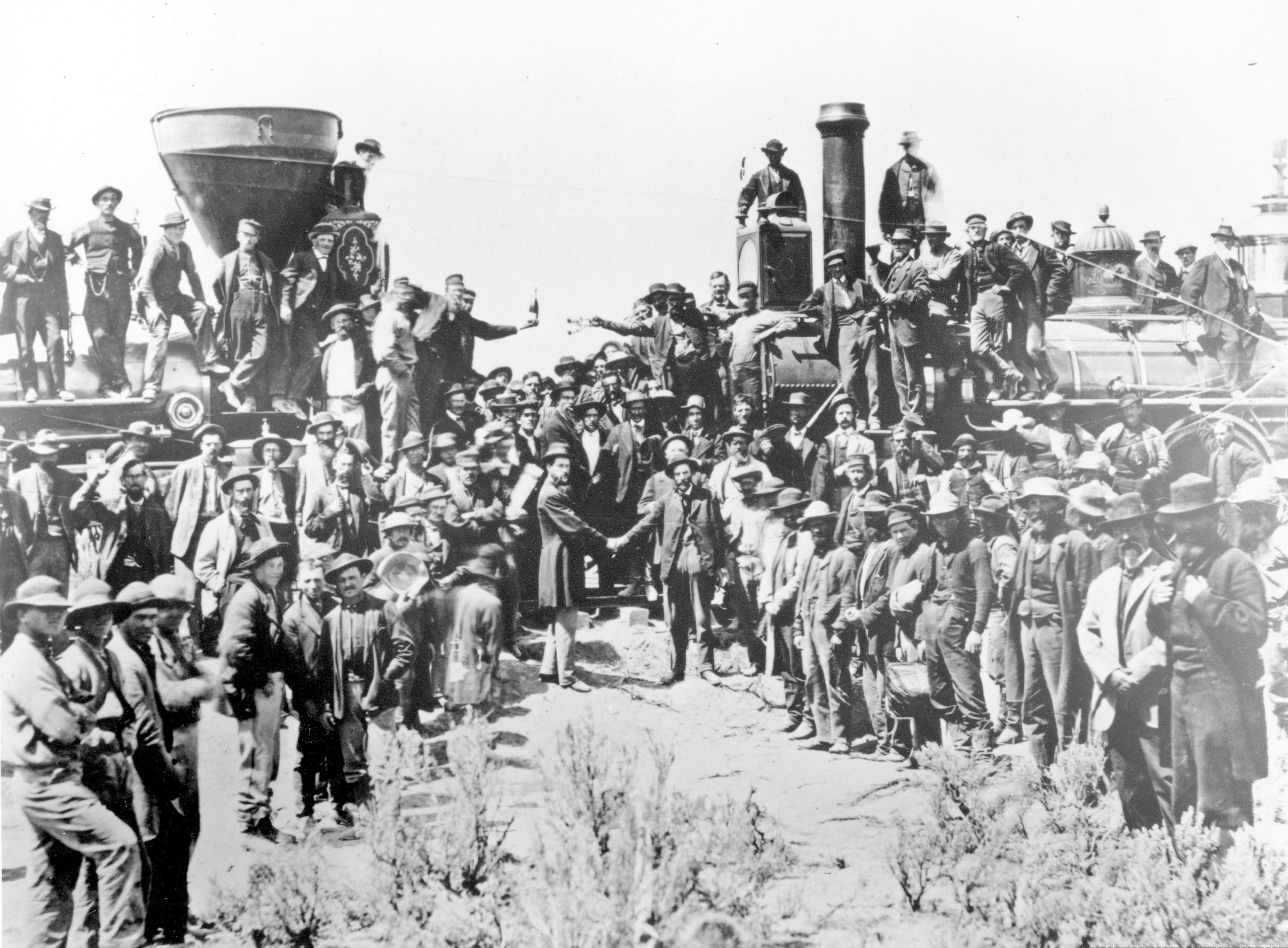(Andrew Russell  |  Union Pacific via AP) In this May 10, 1869, file photo, provided by the Union Pacific, railroad officials and employees celebrate the completion of the first railroad transcontinental link in Promontory, Utah. The completion of the Transcontinental Railroad was a pivotal moment in the United States, ushering in a period of progress and expansion nationwide. The Union Pacific's Locomotive No. 119, right, and Central Pacific's Jupiter edged forward over the golden spike that marked the joining of the nation by rail.