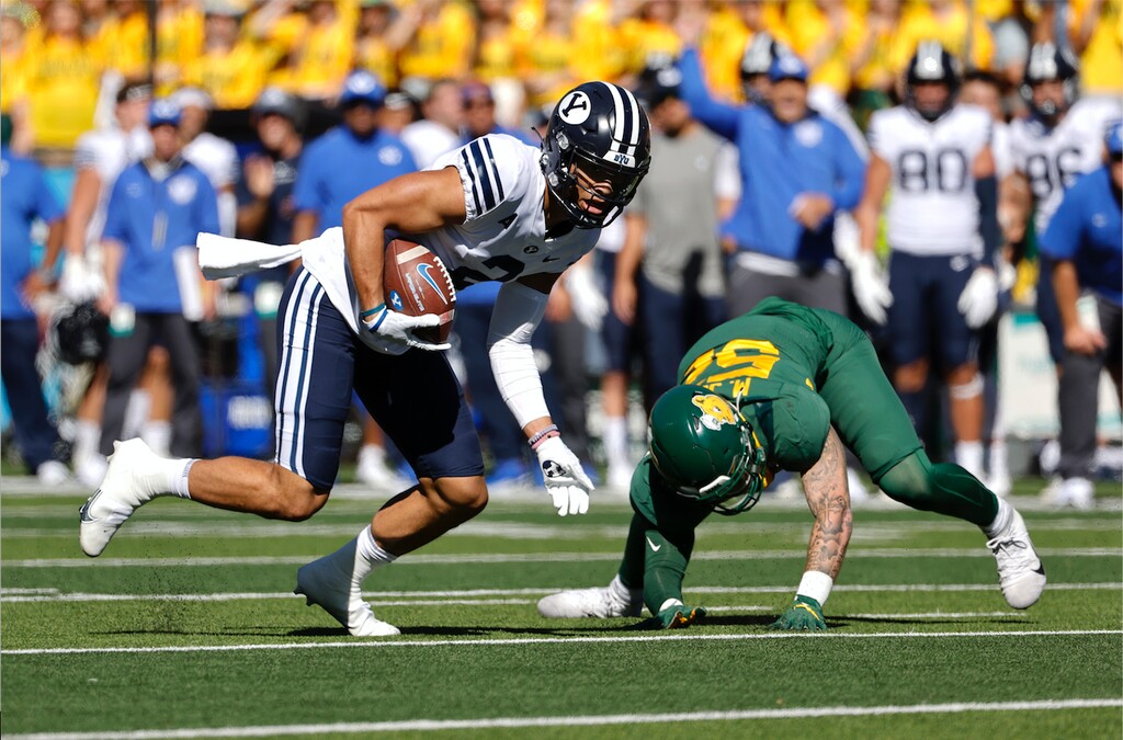 BYU wide receiver Neil Pau'u (2) takes a pass for a first down as he gets by Baylor linebacker Matt Jones (52) during the first half of an NCAA college football game Saturday, Oct. 16, 2021, in Waco, Texas. Baylor won the game 38-24. (AP Photo/Ron Jenkins)