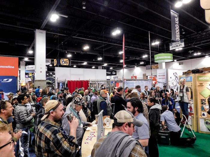 (Erin Alberty | The Salt Lake Tribune) Outdoor Retailer attendees enjoy beer and reach for a free T-shirt  sailing over the crowd at the massive trade show Jan. 27, 2018 at the Colorado Convention Center in Denver.