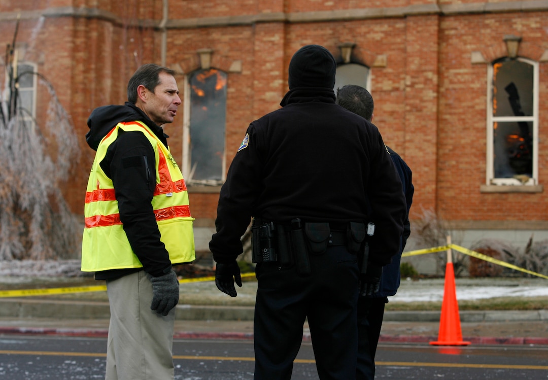 (Rick Egan   |  Tribune file photo)  Provo Mayor John Curtiss (yellow vest) talks to Provo policemen in front of the Provo Tabernacle, Friday, December 17, 2010.  