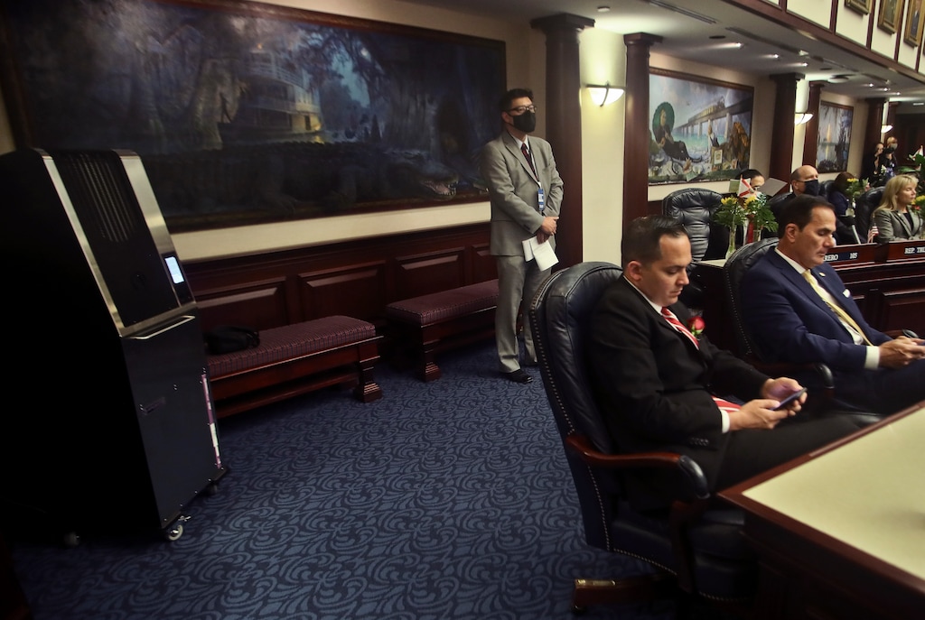(Phil Sears | AP) At far left, an Aerobiotix air purifier is at work on the floor of the House of Representatives Tuesday, March 2, 2021 during Opening Day at the Capitol in Tallahassee, Fla. Studies show air filters and ventilation can help reduce the spread of viruses.