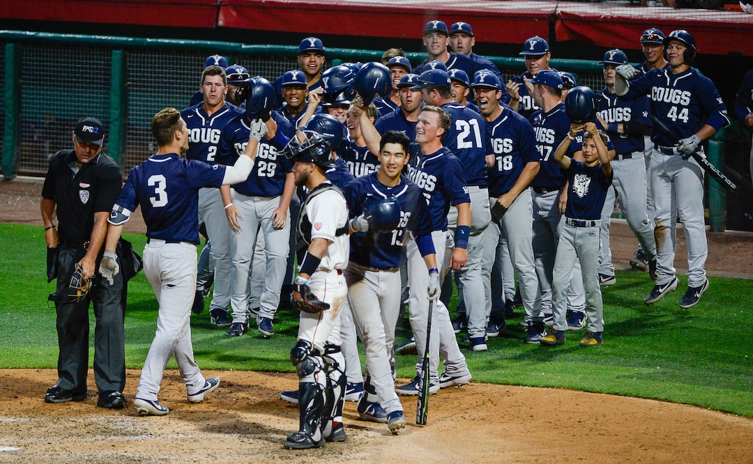 (Francisco Kjolseth  |  The Salt Lake Tribune)  BYU's Danny Gelalich, #3, is celebrated by his teammates as he helps put in the runs as Utah and BYU renew their rivalry on the baseball diamond as they battle it out at Smith's Ballpark in Salt Lake City on Tuesday, May 14, 2019.