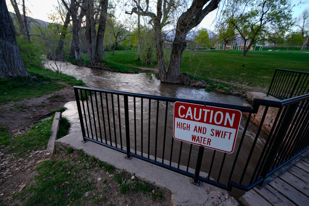 (Francisco Kjolseth | The Salt Lake Tribune) Parleys Creek surges through Sugar House Park, which is designed as a detention basin and remains closed as high water levels continue to fluctuate on Wednesday, May 3, 2023.