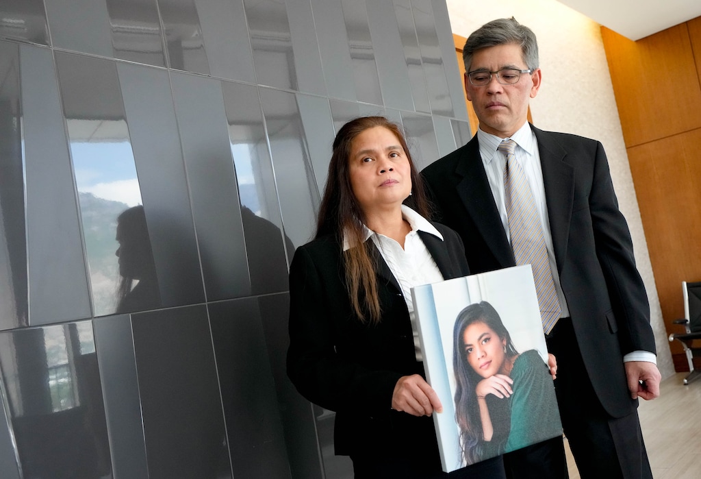 (Francisco Kjolseth | The Salt Lake Tribune) Rose and Keith Nguyen hold a picture of their daughter, Rena, in 4th District Court in Provo on Friday, July 17, 2026. Caleb Rees, who had been dating Rena Nguyen, had just been sentenced on a manslaughter conviction that stemmed from his abuse of her before her death by suicide.