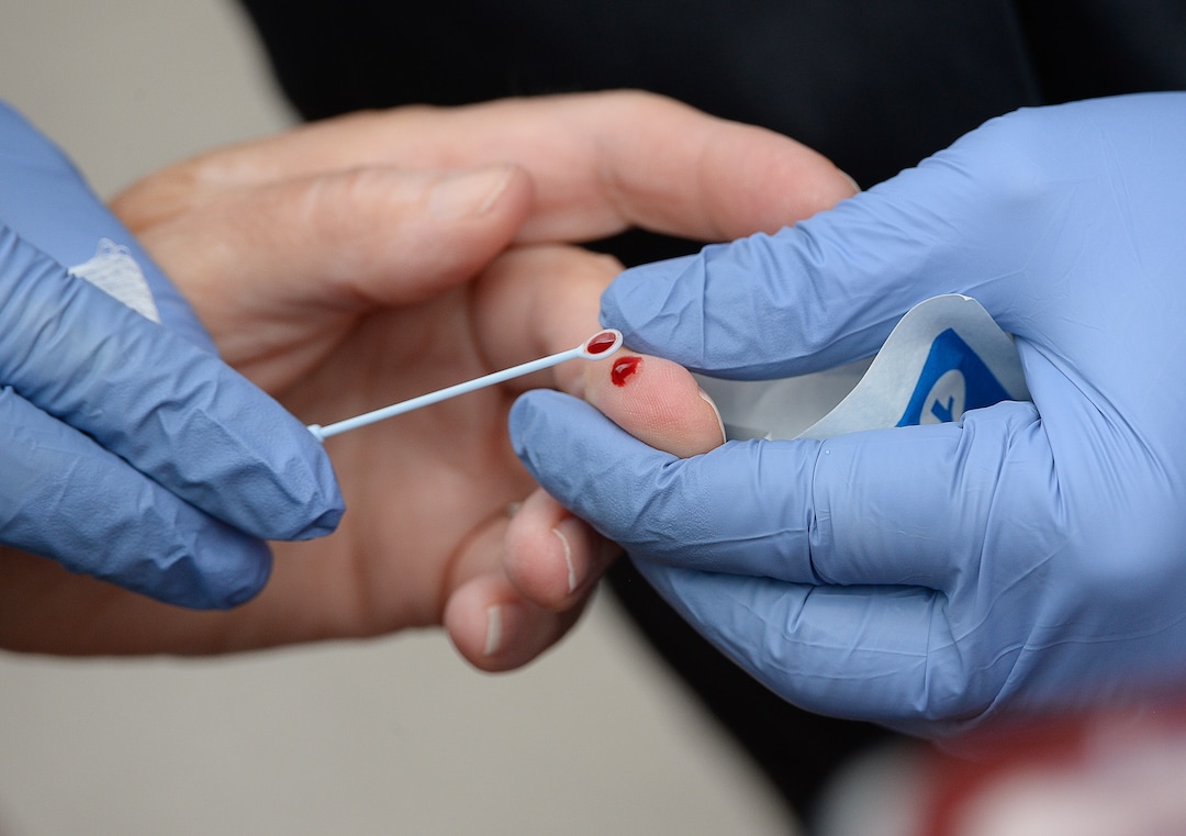 (Francisco Kjolseth  |  The Salt Lake Tribune) A small drop of blood is drawn by a registered nurse as people line up in their cars for COVID-19 antibody testing at the Galena Hills Park in Draper on Wednesday, May 20, 2020.