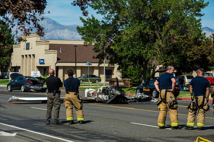(Chris Detrick  |  The Salt Lake Tribune)  The scene of a plane crash at 1900 West and 4500 South  in Roy Tuesday, September 12, 2017. The pilot of a single-engine airplane survived a fiery crash on a street in Roy Tuesday afternoon, authorities said. Roy police Sgt. Matthew Gwynn said the pilot was transported to a hospital “out of precaution,” as was the driver of a car that the plane hit.