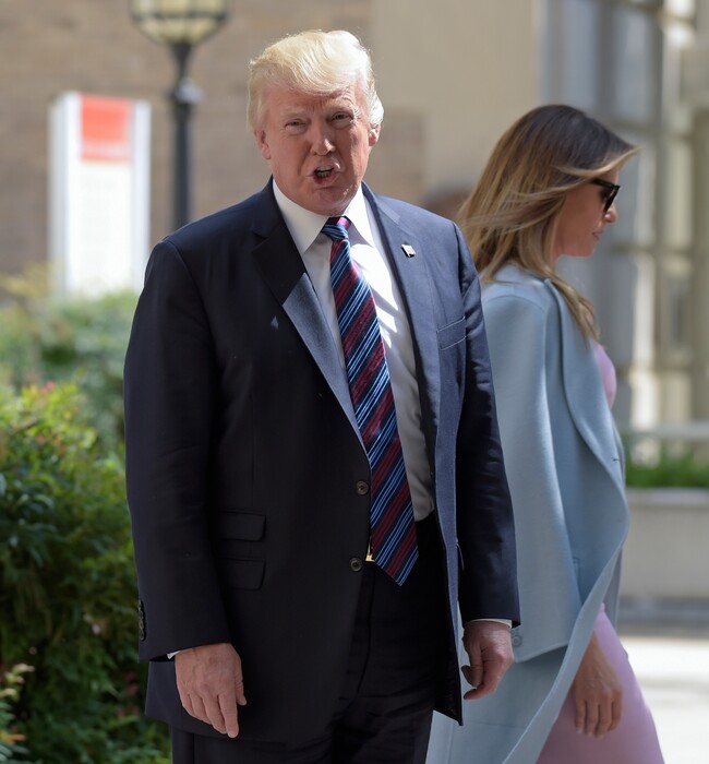 President Donald Trump, with first lady Melania Trump with him, responds, "We'll see," as he is asked a question about attacking North Korea after the Trump's attended services at St. John's Church in Washington, Sunday, Sept. 3, 2017. The president last week named today a National Day of Prayer for victims of Hurricane Harvey. (AP Photo/Susan Walsh)