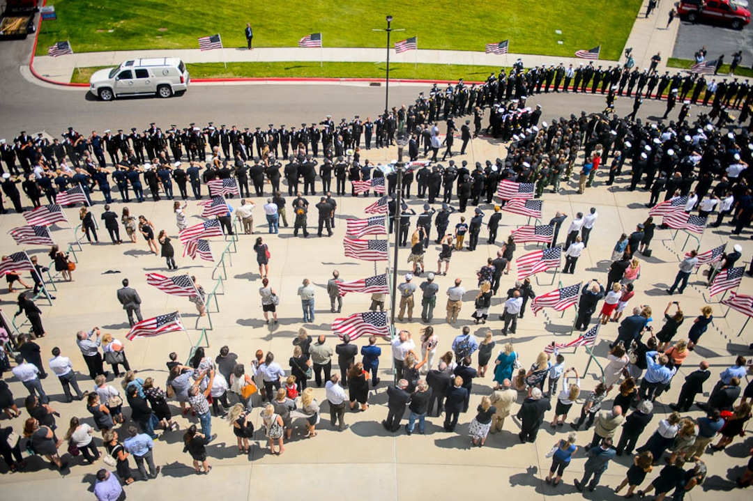 (Trent Nelson | The Salt Lake Tribune)  Funeral services for Battalion Chief Matthew Burchett at the Maverik Center in West Valley City, Monday Aug. 20, 2018.