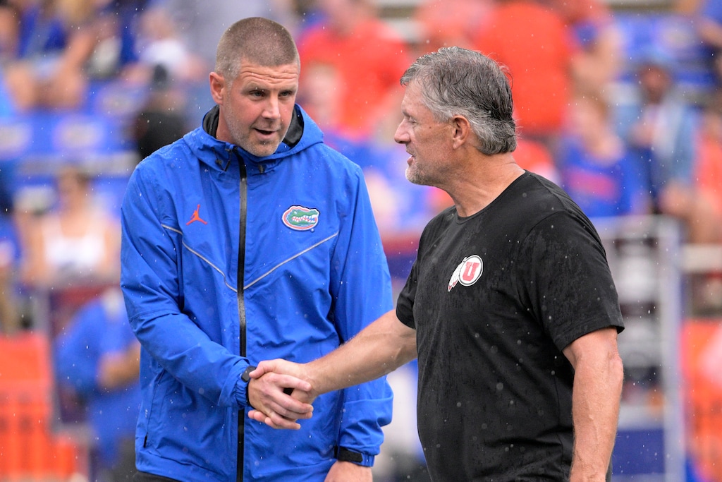 (Phelan M. Ebenhack | AP) Florida head coach Billy Napier, left, and Utah head coach Kyle Whittingham, right, shake hands on the field before an NCAA college football game, Saturday, Sept. 3, 2022, in Gainesville, Fla.