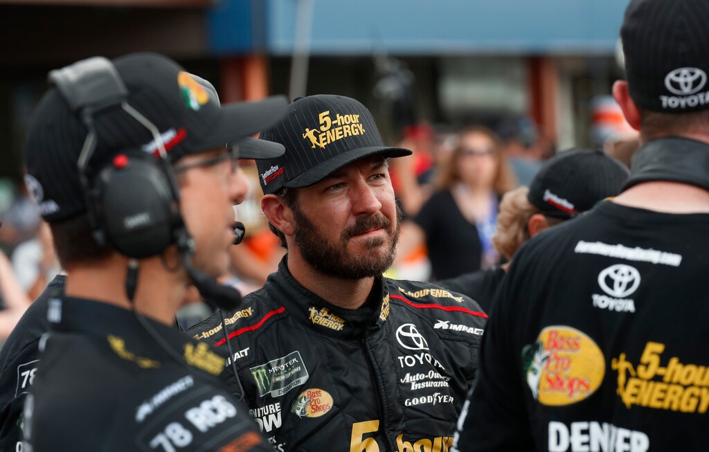Martin Truex Jr. watches times during qualifications for a NASCAR Cup Series auto race at Michigan International Speedway in Brooklyn, Mich., Friday, Aug. 10, 2018. (AP Photo/Paul Sancya)