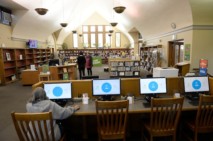 (Al Hartmann | The Salt Lake Tribune)
People trickle in to the re-opened Sprague Library Monday Oct. 23 with limited service after its basement flooded in July, causing a loss of thousands of books. The main floor of the English Tudor style building is open and rearranged. The basement which housed non-fiction, children's books, and community meeting rooms will remain closed for some time.