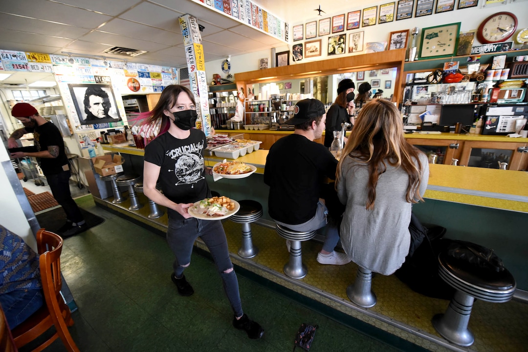 (Francisco Kjolseth  | The Salt Lake Tribune) Leslie Powers delivers breakfast plates past the long counter that will soon see a new home in historic Helper, Utah. Salt Lake City's Blue Plate Diner will be closing on May 4, after 20 years in business. A new development is going in on the corner that is forcing it to shut down.