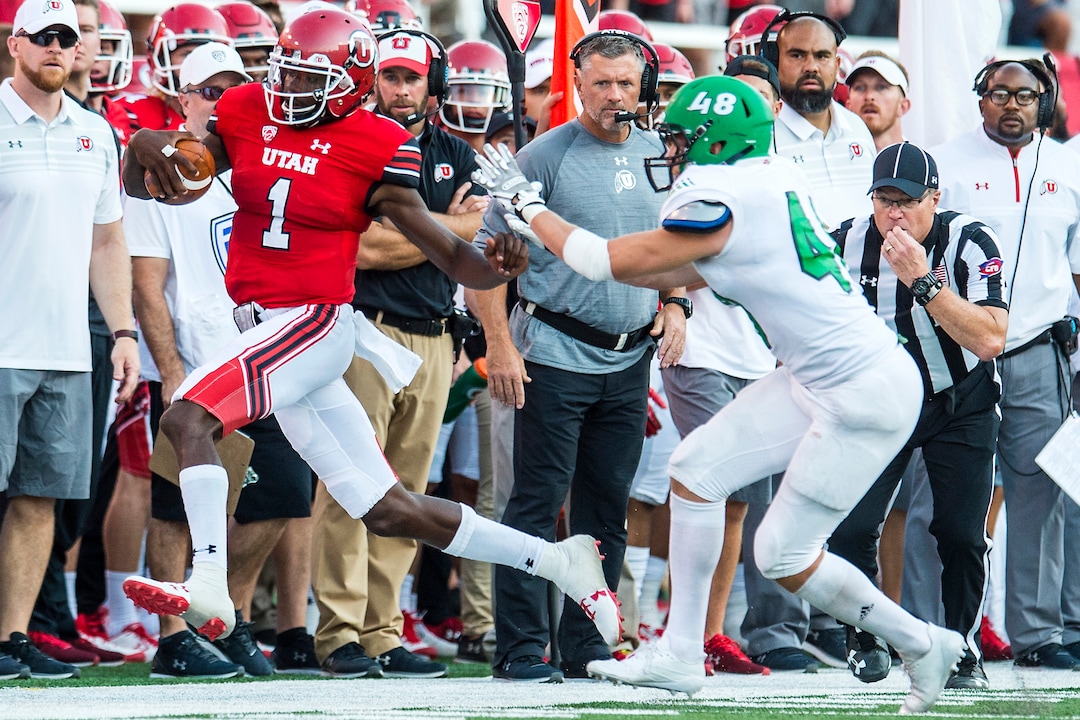 (Chris Detrick  |  The Salt Lake Tribune)  Utah Utes head coach Kyle Whittingham watches as Utah Utes quarterback Tyler Huntley (1) is pushed out of bounds by North Dakota Fighting Hawks linebacker Jake Disterhaupt (48) during the game at Rice-Eccles Stadium Thursday, August 31, 2017. Utah Utes are leading North Dakota Fighting Hawks 17-9 at halftime. 