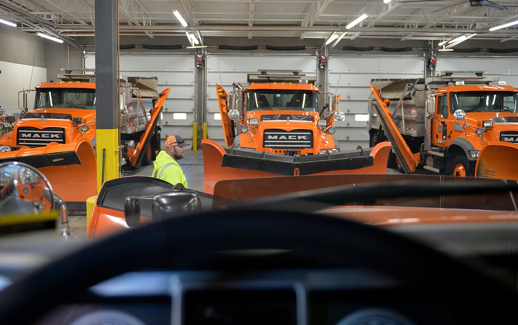 (Chris Samuels | The Salt Lake Tribune) Jake Brown walks by snowplows at a UDOT facility in Cottonwood Heights, Thursday, Dec. 2, 2021. A labor shortage could affect the number of snowplows that can be on the road this winter. Brown says 60% of the facility's workers have turned over in the past year.