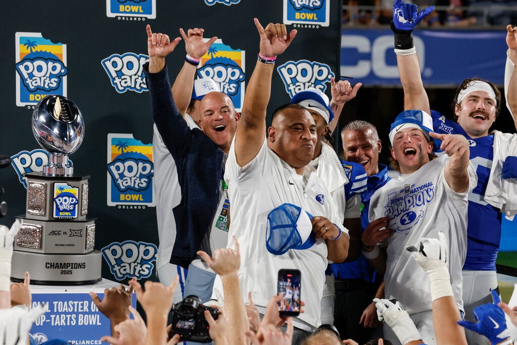 (Kevin Kolczynski | AP) BYU head coach Kalani Sitake eats a Pop-Tart during the trophy presentation after defeating Georgia Tech at the Pop-Tarts Bowl on Saturday.