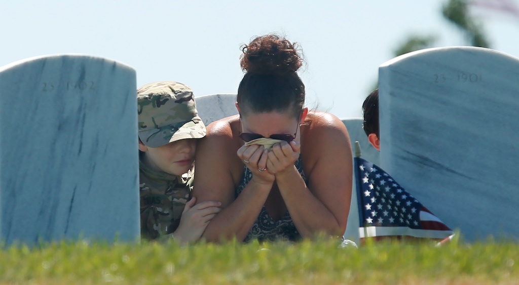 (Rich Pedroncelli | The Associated Press) Heidi Hannah holds her head in her hands, as she is joined by her sons Tomas, 10, left, and Lucas, 8, right, at a Memorial Day visit to the grave of her oldest son, Army Specialist Taylor Hannah, at the Sacramento Valley National Cemetery in Dixon, Calif., Monday, May 25, 2020. Public Memorial Day events at the cemetery were canceled this year due to the coronavirus pandemic. Taylor Hannah, 22, died March 1, 2020 of a rare blood disease.
