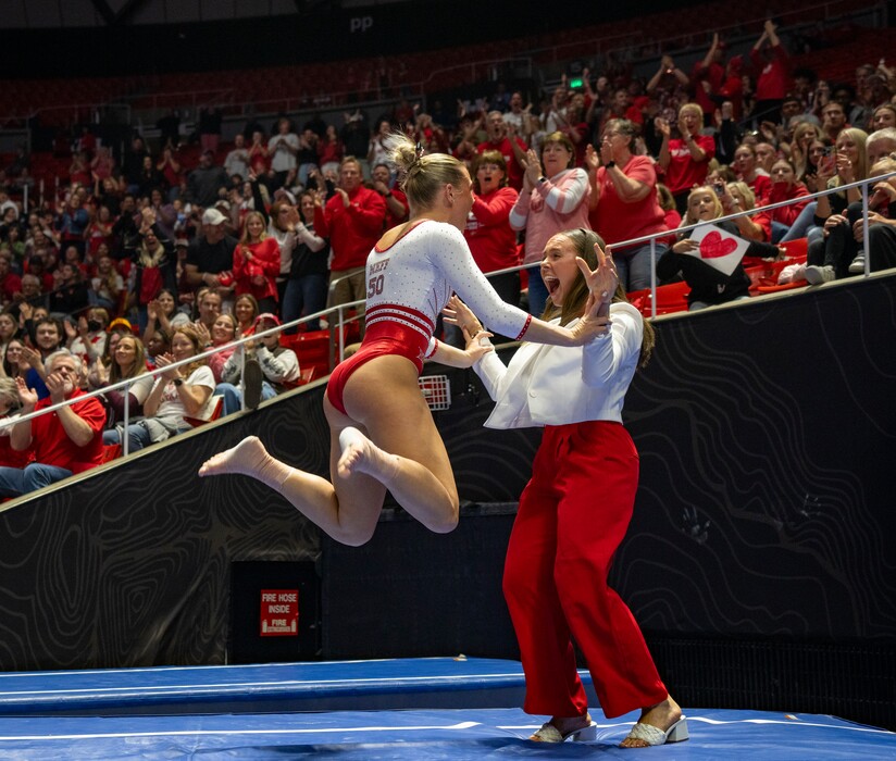 (Rick Egan | The Salt Lake Tribune) Avery Neff, left, celebrates with student assistant coach Maile O'Keefe after her vault in the NCAA regional semifinals at the Jon M. Huntsman Center on Thursday, April 3, 2025. The Red Rocks are scheduled to compete in the NCAA Championships on April 17 and 19, 2025.