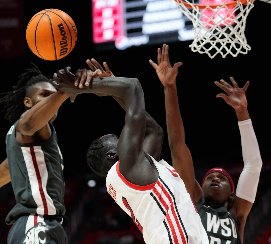 (Francisco Kjolseth | The Salt Lake Tribune) Utah Utes guard Both Gach (2) is blocked by the Washington State Cougars defense in game action during an NCAA college basketball game at the Jon M.Huntsman Center, on Saturday, Jan. 8, 2022. Utah lost 61-77.