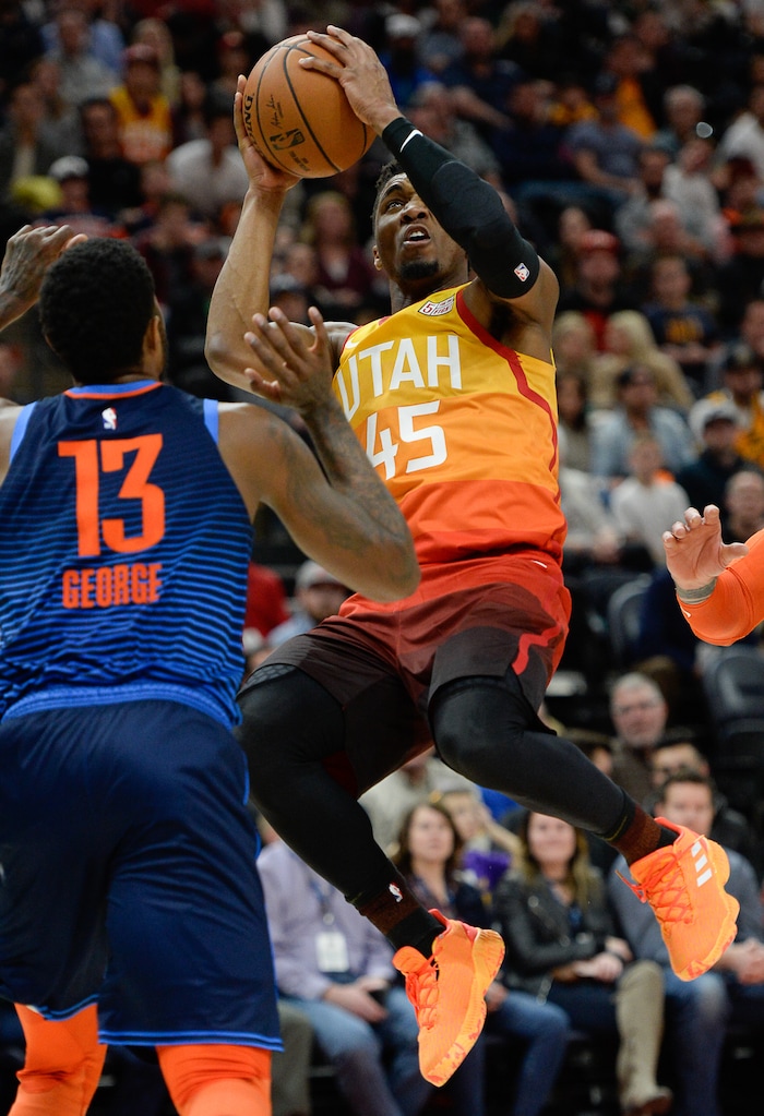 (Francisco Kjolseth  |  The Salt Lake Tribune)   Utah Jazz guard Donovan Mitchell (45) keeps his eye on the basket as he battles the Thunder in the NBA game at Vivint Smart Home Arena Sat., Dec. 22, 2018, in Salt Lake City.
