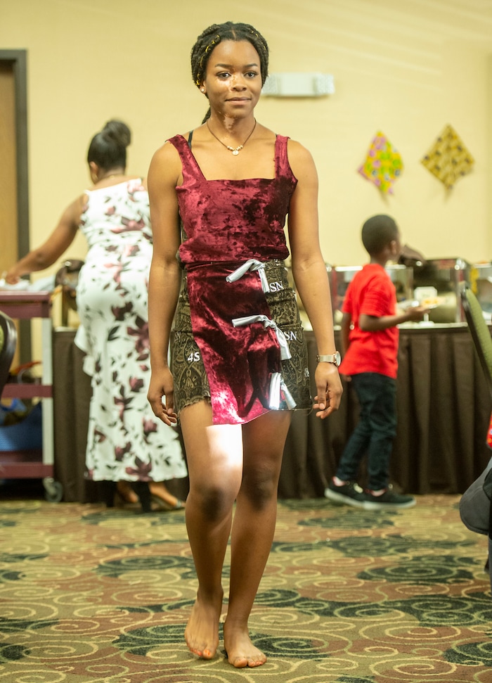 (Rick Egan  |  The Salt Lake Tribune)     Nadine Bahati models an outfit designed by her sister Sylviane Bahati, during a fashion show, graduation celebration. Saturday May 25, 2019