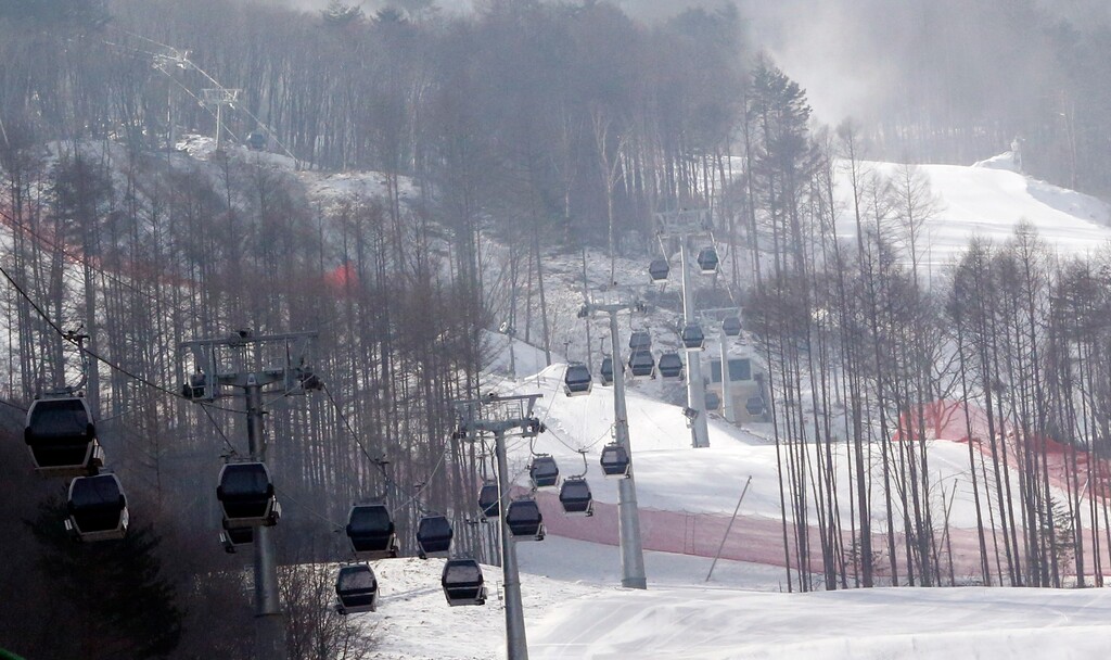 FILE - In this Friday, Jan. 22, 2016, file photo, gondolas make their way through a thinned forest up the ski slope which would be the venue for the Pyeongchang 2018 Winter Olympics at the Jeongseon Alpine Center in Jeongseon, South Korea. With the Olympic Games coming to a close, one of the main questions facing South Korea and the consequences of hosting an expensive sports event is the future of the scenic Jeongseon Alpine Center, which was built in a formerly government-protected area where some 60,000 trees were razed. (AP Photo/Lee Jin-man)