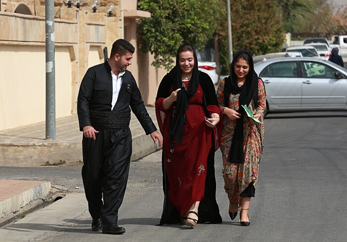 Iraqi Kurdish people leave a polling center after casting their votes during the referendum on independence from Iraq in Irbil, Iraq, Monday, Sept. 25, 2017. Iraq's Kurdish region vote in a referendum on whether to secede from Iraq. (AP Photo/Khalid Mohammed)