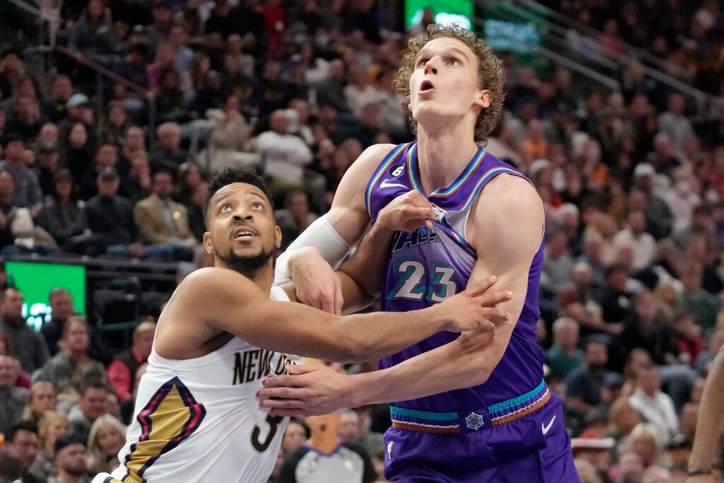 New Orleans Pelicans guard CJ McCollum (3) and Utah Jazz forward Lauri Markkanen (23) battle for position under the boards during the first half of an NBA basketball game Thursday, Dec. 15, 2022, in Salt Lake City. (AP Photo/Rick Bowmer)