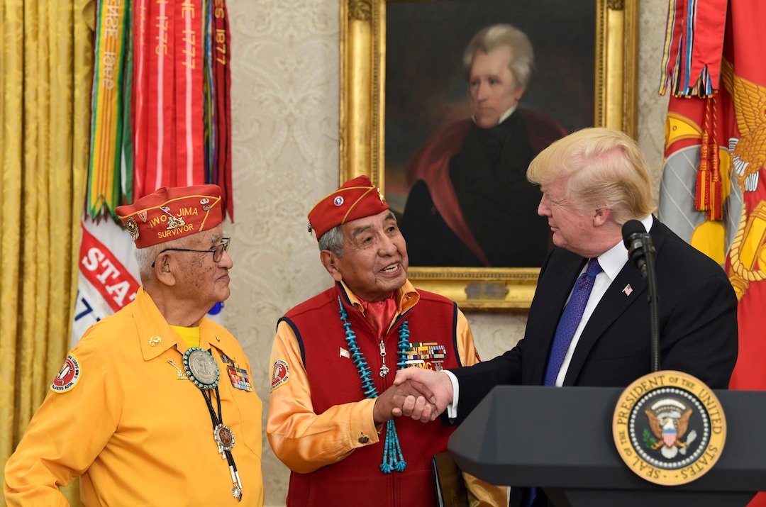 President Donald Trump, right, meets with Navajo Code Talkers Peter MacDonald, center, and Thomas Begay, left, in the Oval Office of the White House in Washington, Monday, Nov. 27, 2017. (AP Photo/Susan Walsh)