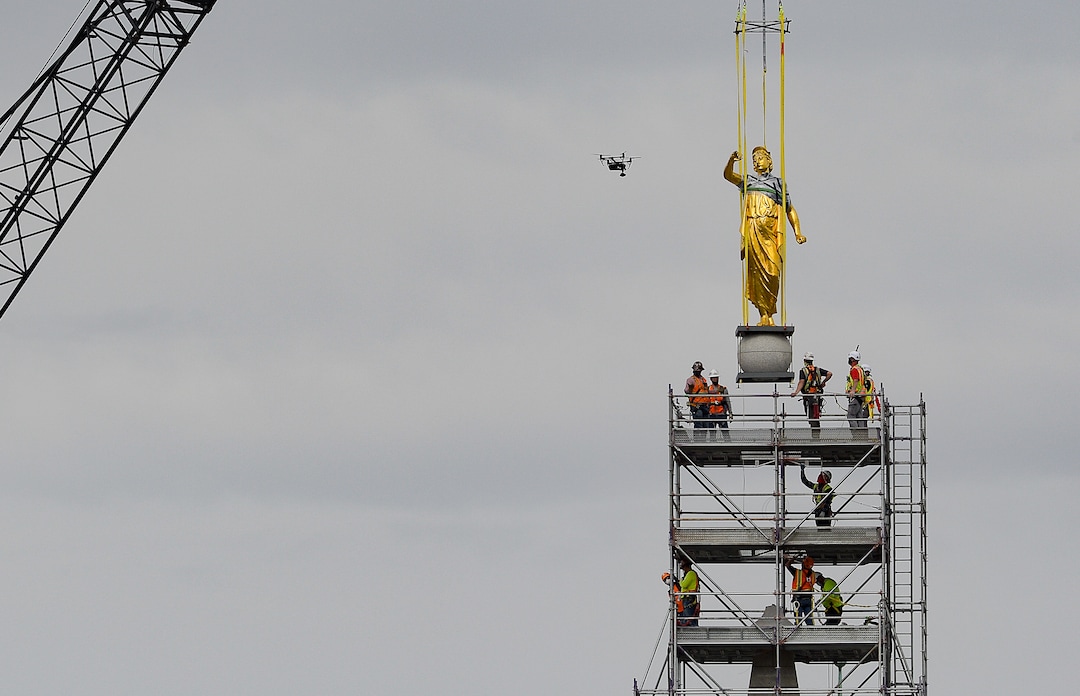 (Francisco Kjolseth  |  The Salt Lake Tribune) Crews work to remove the Angel Moroni statue atop the Salt Lake Temple of The Church of Jesus Christ of Latter-day Saints on Monday, May 18, 2020. The temple closed in December for seismic upgrades and sustained minor damager during the March 18, 2020, magnitude 5.7 earthquake when the trumpet held by the angel fell off and several smaller spire stones were displaced.
