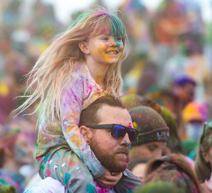 (Rick Egan  |  The Salt Lake Tribune)   Jaycee, 4, gets a good view of the festivities from her dad Parker Haworth's shoulders, at the Holi Festival of Colors celebration at the Sri Sri Radha Krishna Temple in Spanish Fork, Saturday, March 30, 2019.
 