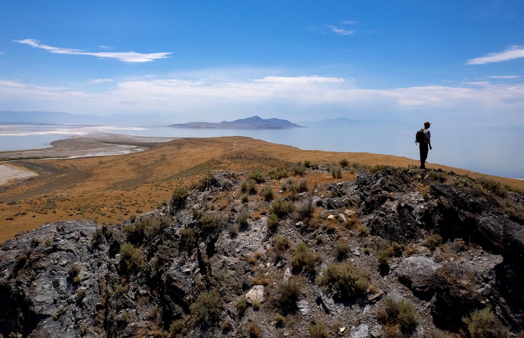 (Francisco Kjolseth | The Salt Lake Tribune) Arie Leeflang, archeologist at Utah Division of Wildlife Resources and the site steward for Fremont Island, takes in the view from the highest point with Antelope Island in the distance on Tuesday, July 18, 2023.