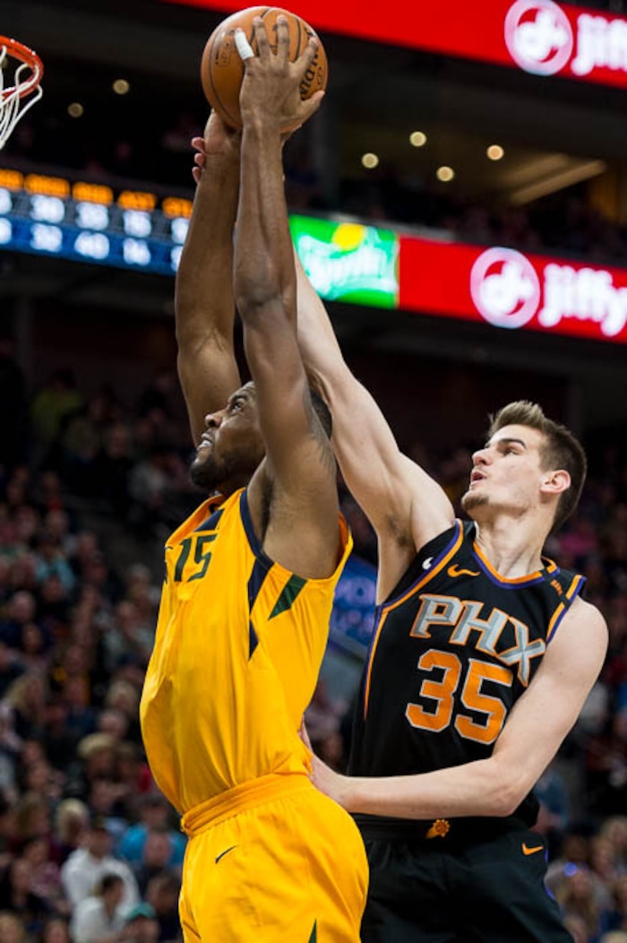 (Trent Nelson | The Salt Lake Tribune)  Utah Jazz forward Derrick Favors (15) is fouled by Phoenix Suns forward Dragan Bender (35) as the Utah Jazz host the Phoenix Suns, NBA basketball in Salt Lake City, Wednesday Feb. 14, 2018.