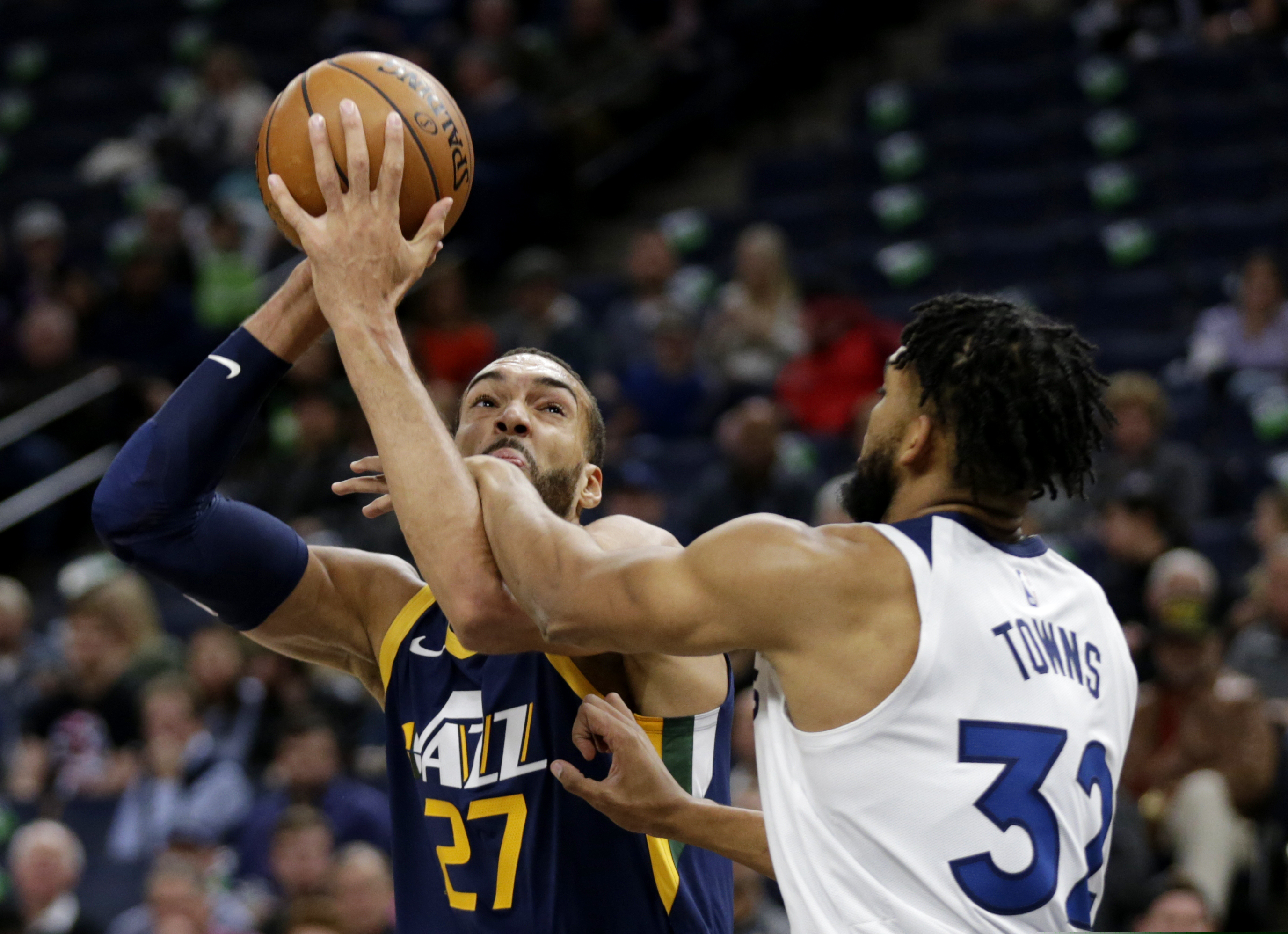 Utah Jazz center Rudy Gobert (27) is fouled by Minnesota Timberwolves center Karl-Anthony Towns (32) in the first quarter of an NBA basketball game Wednesday, Nov. 20, 2019 in Minneapolis. (AP Photo/Andy Clayton- King)