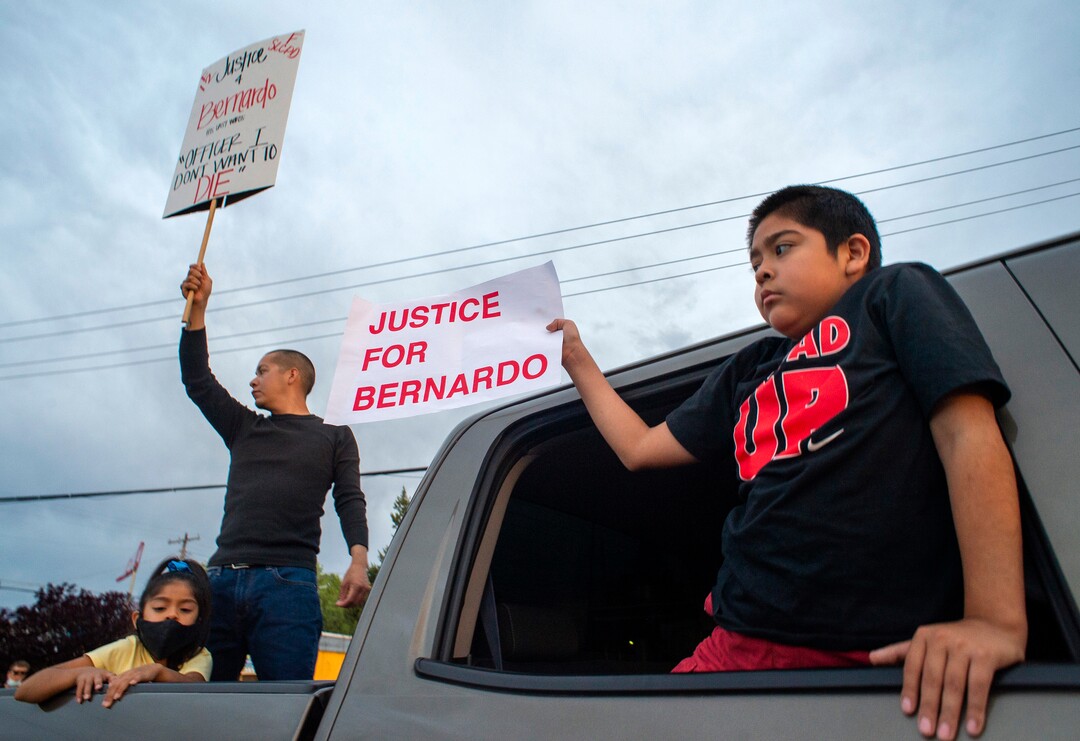 (Rick Egan  |  The Salt Lake Tribune) Josh and Aydn Palacios hold signs as the marchers stop at the memorial for Bernardo Palacios-Carbajal during a demonstration on 900 South 300 West in Salt Lake City on Saturday, June 13, 2020.