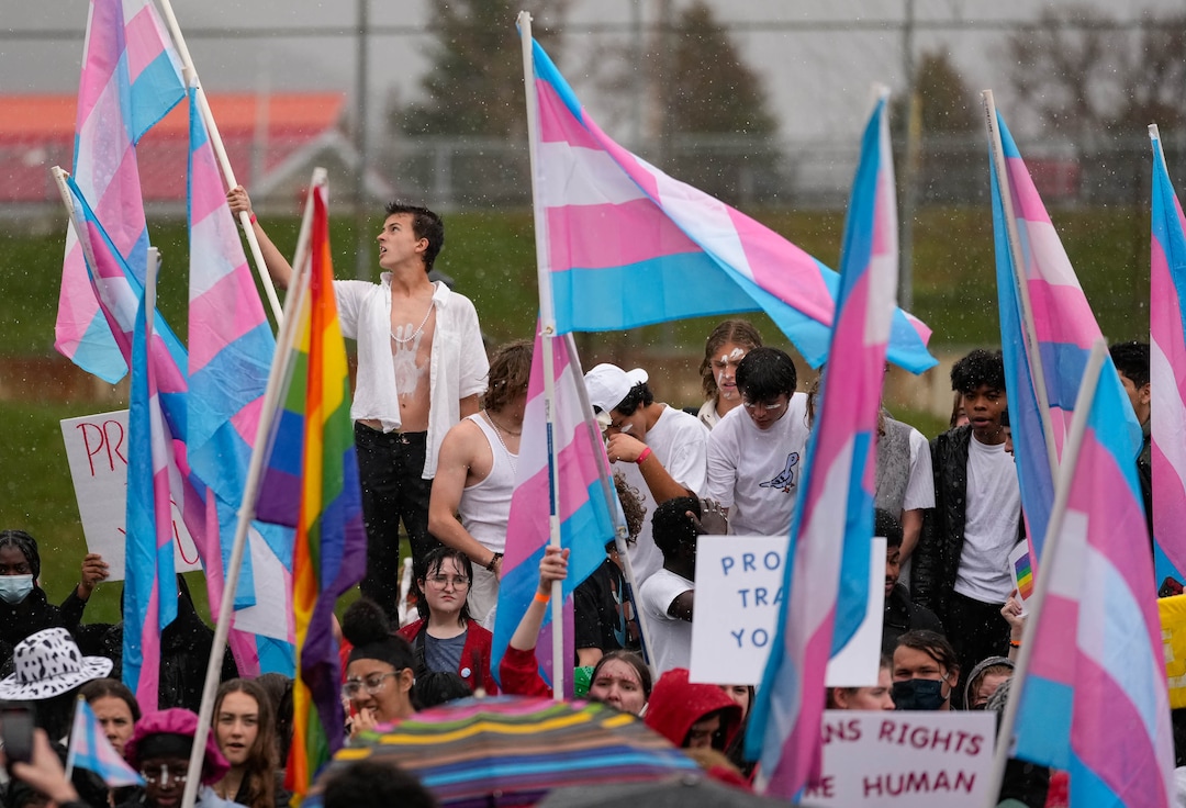 (Francisco Kjolseth | The Salt Lake Tribune) Standing in the rain, East High school students walkout on Friday, April 15, 2022, to protest HB11, which bans transgender girls from participating in female school sports. In the same spirit of the West High walkout last week, students took a stand to speak out against the bill which they found discriminatory and hurtful to transgender youth in the state.
