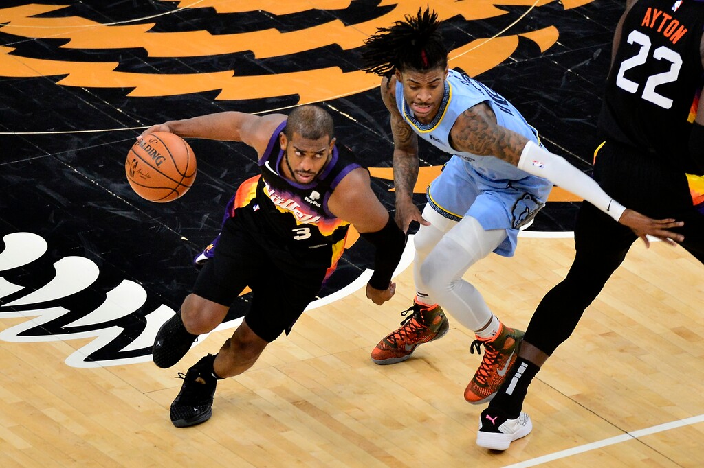 Phoenix Suns guard Chris Paul (3) drives against Memphis Grizzlies guard Ja Morant in the first half of an NBA basketball game Saturday, Feb. 20, 2021, in Memphis, Tenn. (AP Photo/Brandon Dill)