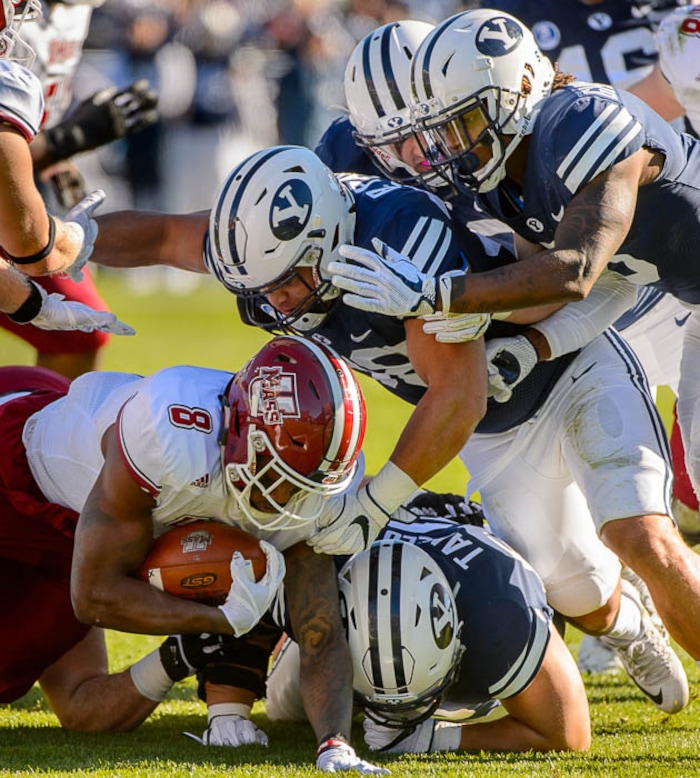 (Trent Nelson | The Salt Lake Tribune)  Massachusetts Minutemen running back Marquis Young (8) is stopped by BYU defenders as BYU hosts the University of Massachusetts, NCAA football in Provo, Saturday November 18, 2017.