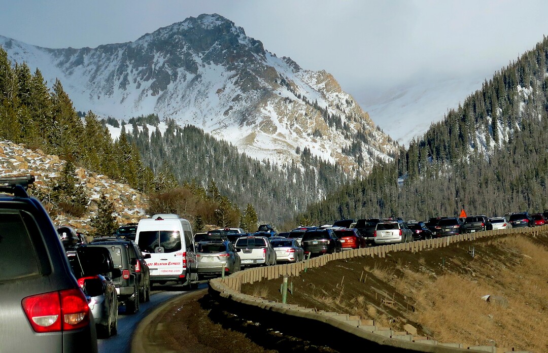 In this Jan. 7, 2018, photo, traffic backs up on Interstate 70 in Colorado, a familiar scene on the main highway connecting Denver to the mountains The chairman of a committee exploring whether Denver should bid on the 2030 Olympics says buses or giving incentives to truckers to avoid the highway could help keep traffic moving if the city hosted the games. Rob Cohen also says a possible surplus could help pay to improve the highway later. (AP Photo/Thomas Peipert)