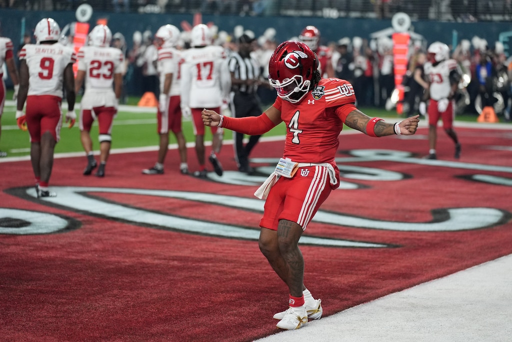 (John Locher | AP) Utah quarterback Devon Dampier (4) celebrates after scoring a touchdown against Nebraska during the first half of the Las Vegas Bowl, Wednesday, Dec. 31, 2025, in Las Vegas.
