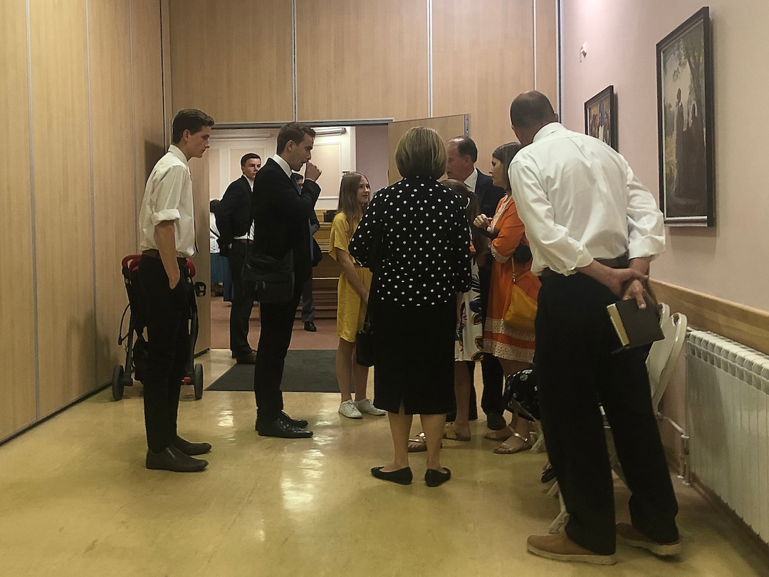 (Michael Stack  | Special to The Salt Lake Tribune) Latter-day Saints and “volunteers” visit outside of St. Petersburg chapel.