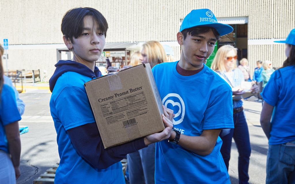 (The Church of Jesus Christ of Latter-day Saints) Jonas and Henry Takagi, JustServe youth volunteers, help move boxes from an America250 food donation onto pallets and load them into South County Outreach trucks for delivery to almost a dozen charities in the Irvine, California, area on Saturday, Feb. 21, 2026.