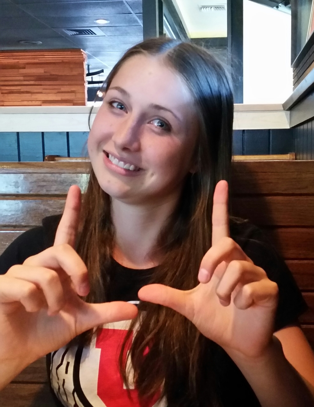 (Photo courtesy of Jill McCluskey) In this undated photo, Lauren McCluskey makes the "U" with her hands.